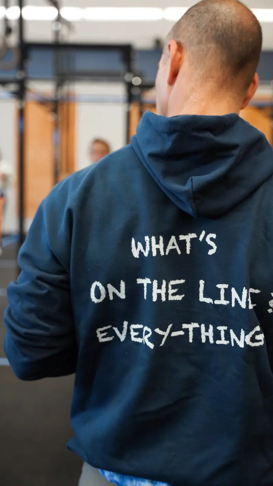 The back of a member's CrossFit OTL hoodie, which reads: What's on the line? Everything.